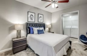 the master bedroom has a comfy bed and a ceiling fan