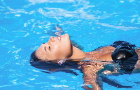 a girl swimming in a pool