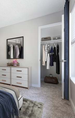 A bedroom with a bed, dresser, and closet.