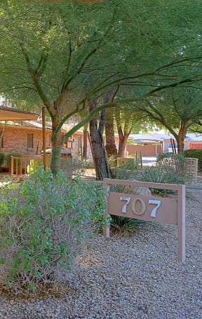 a house with a yard and a sign in front of it