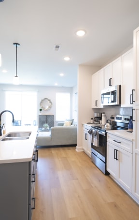 a kitchen with white cabinets and stainless steel appliances