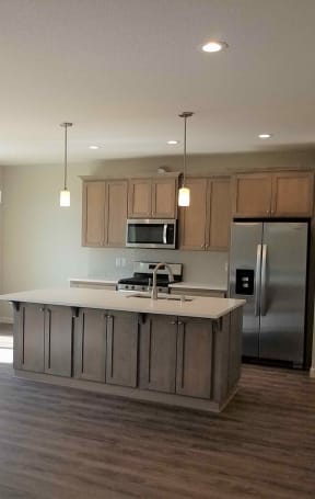 a kitchen with a large island in the middle of it