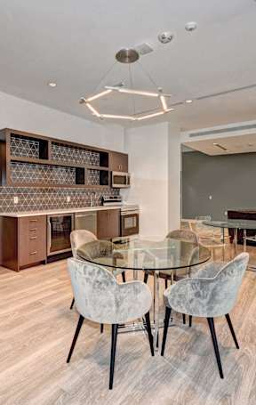 A conference room with a glass table and chairs.