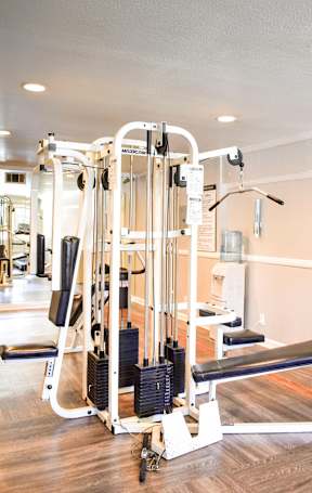A gym with a multi-station weight machine.