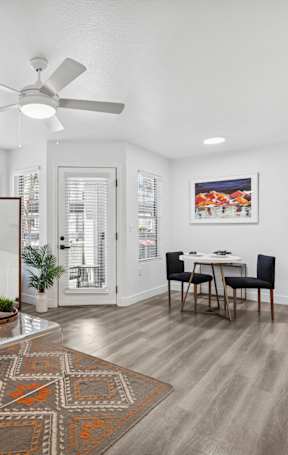 A modern living room with a variety of seating options and a coffee table.