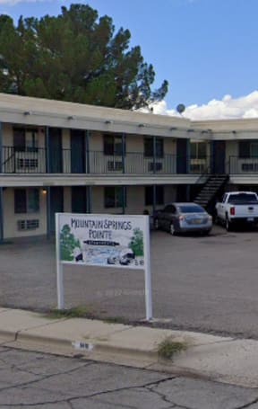a motel with a sign in front of a parking lot