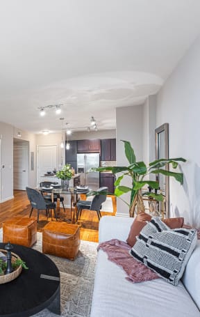 a living room with a couch and a coffee table and a dining room