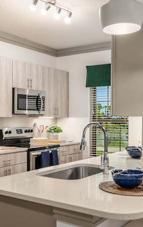 an open kitchen with a granite counter top and stools