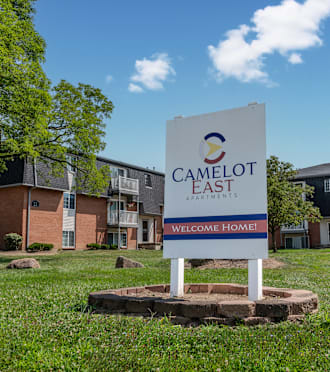 a sign that reads camelot east in front of an apartment building