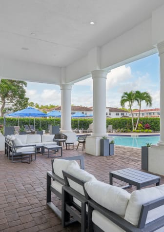 a white house with two garage doors and a driveway at The Falls of Portofino, Florida, 34119