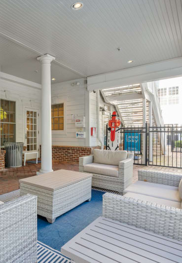 a porch with blue couches and chairs and a table at Sterling Manor, Williamsburg, 23185