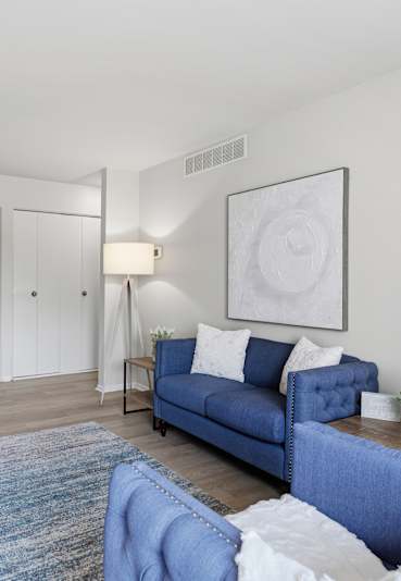 Master bedroom with tufted headboard and abstract artwork at Canterbury Square Apartments, Troy, MI 48083