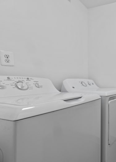 an empty laundry room with a washer and dryer and white walls at Edge At Farmington Hills - Farmington Hills, MI, Michigan, 48334