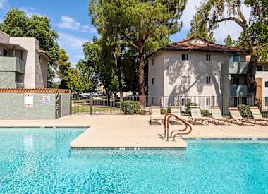 Community swimming pool and surrounding deck at Villa Toscana