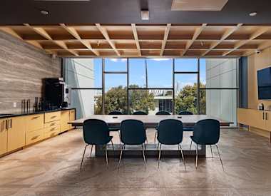 A modern kitchen with a dining table and chairs.