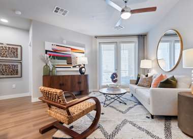 Furnished apartment living area shown at Seven Oaks.