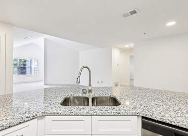 Wesley St. Claire Apartments at Lawrenceville kitchen with island and sink - Lawrenceville, GA