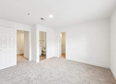 Wesley St. Claire Apartments at Lawrenceville bedroom with carpet and closet doors - Lawrenceville, GA