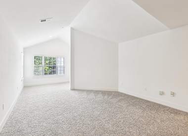 Wesley St. Claire Apartments at Lawrenceville bedroom with carpet and window - Lawrenceville, GA