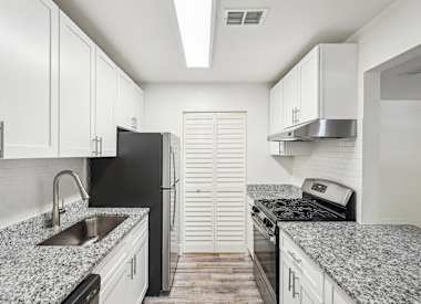 Wesley Trevento Apartments at Lithia Springs kitchen with granite countertops and stainless appliances - Lithia Springs, GA