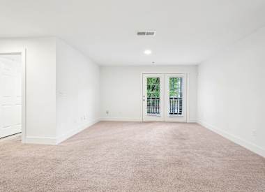 Wesley Hampstead Apartments at Douglasville bedroom with carpet and double doors - Lithia Springs, GA