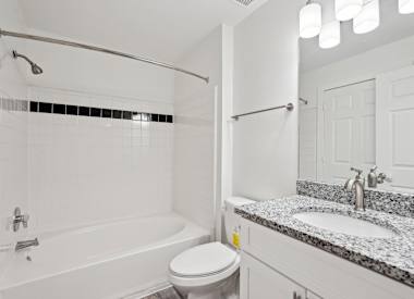 Wesley Hampstead Apartments at Douglasville bathroom with tub, toilet and vanity - Lithia Springs, GA