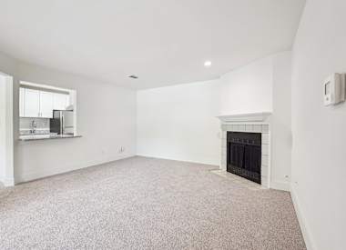 Wesley Trevento Apartments at Lithia Springs living room with carpet and fireplace - Lithia Springs, GA
