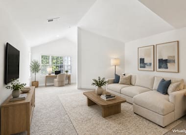 Virtually staged: Wesley St. Claire Apartments at Lawrenceville living room with sectional sofa and coffee table - Lawrenceville, GA