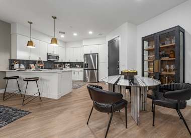 Furnished dining area shown at Aura Uptown.