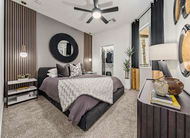 Furnished bedroom shown at Aura Uptown.