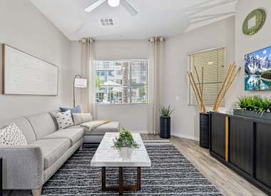 Furnished apartment living area shown at Axis Camelback.