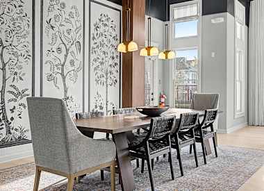 A dining room with a table and chairs.