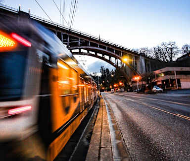 a train traveling down the tracks in a city