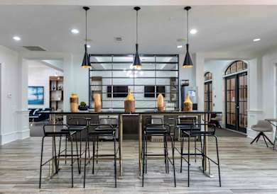 A modern kitchen with a large island and bar stools.