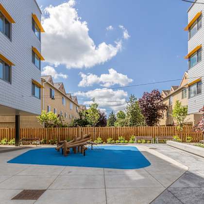 a modern building with a blue pool in the courtyard.