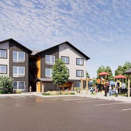 a modern building with a parking lot in front.