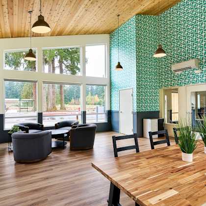 a large living room with a wooden table and chairs