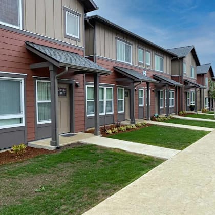 a row of houses with brown and grey siding.
