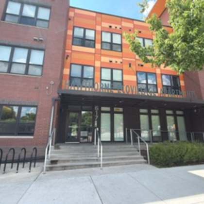 the image shows a building with a glass entrance and a sign that reads "love".