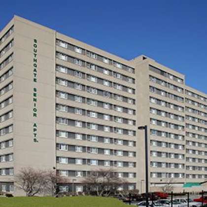 a large beige building with the words "downtown student apartments" on the side.