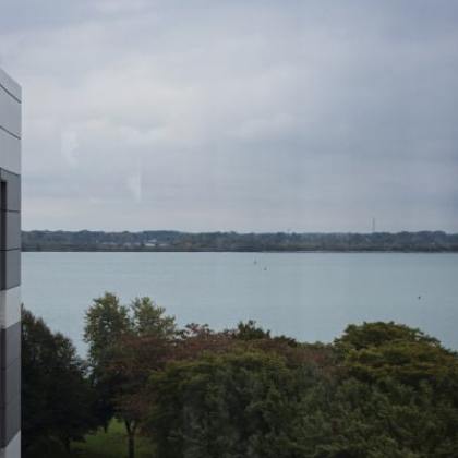 a view of a body of water from a high vantage point with a building on the left side.