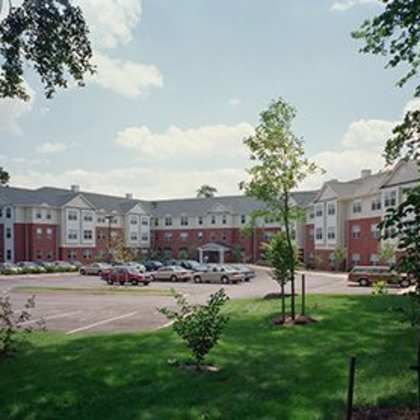 a parking lot in front of a red brick building.