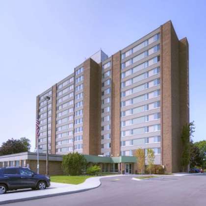 a tall building with a parking lot in front of it.
