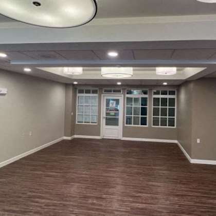 a room with brown flooring and a white ceiling.