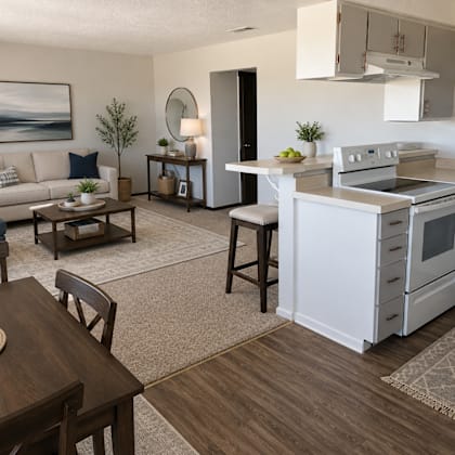 a modern kitchen and living room with a dining table and chairs.