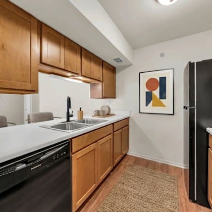 a kitchen with wooden cabinets and black appliances.