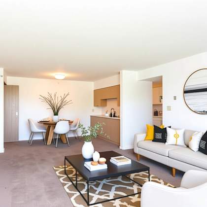 a living room with a white couch and a coffee table.
