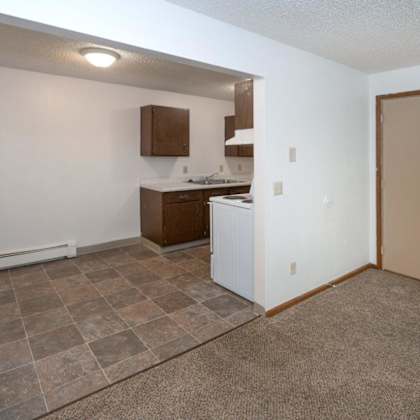 a kitchen with a stove and a sink in a small room