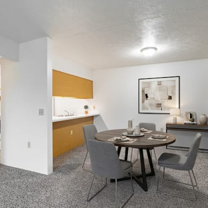 a dining room with a table set for four.