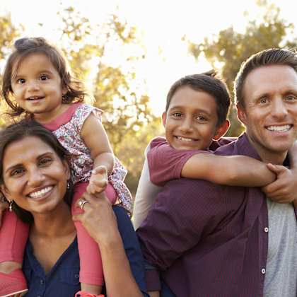 a family posing for a picture in a park